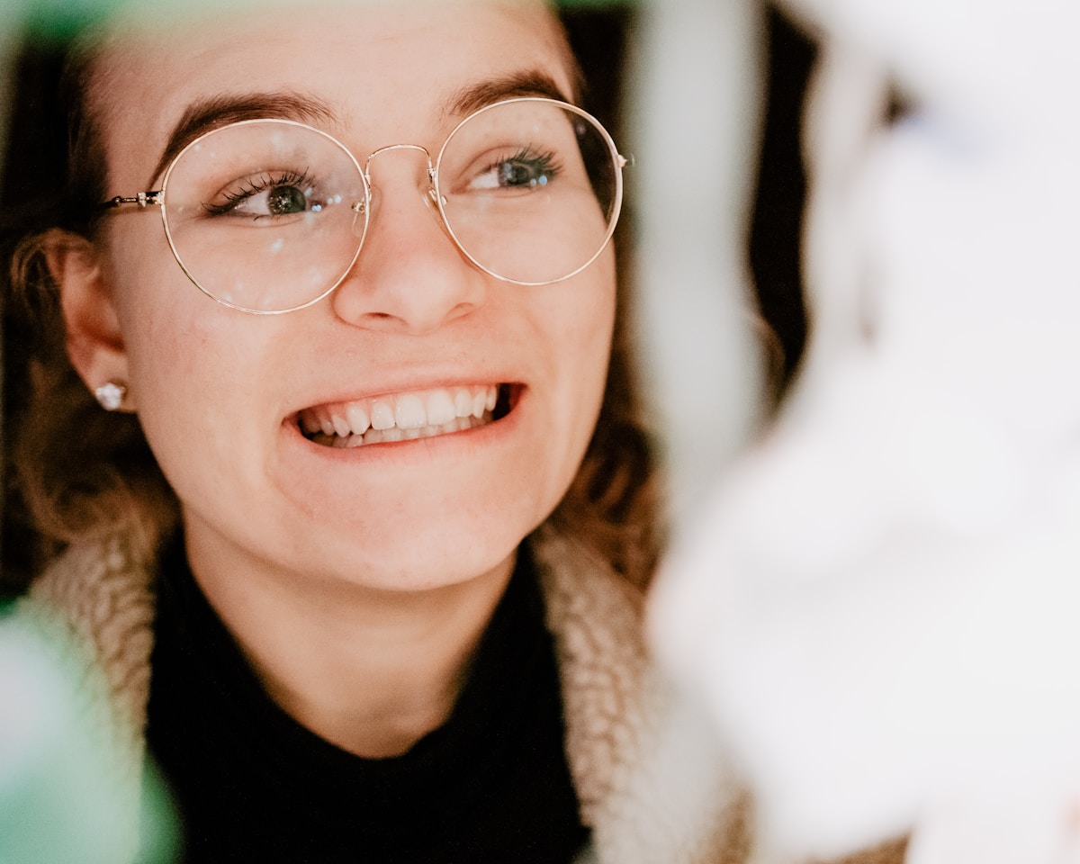 A smiling patient wearing glasses